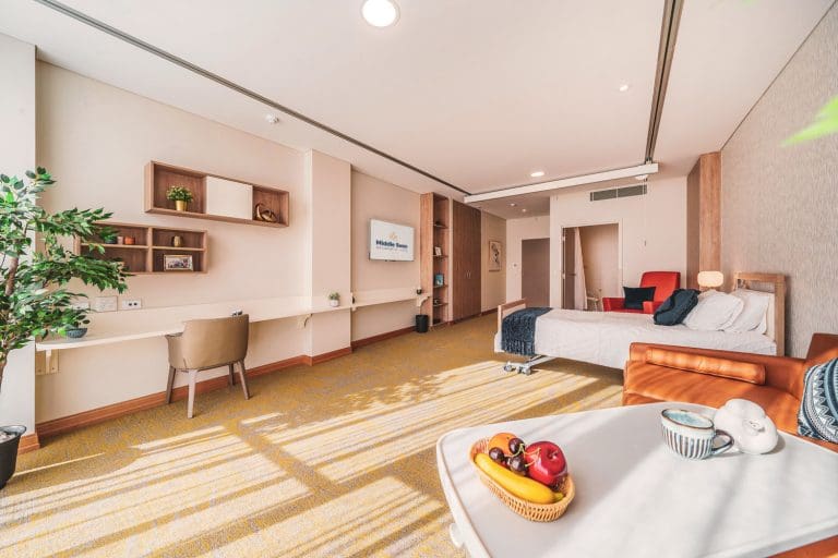 Large aged care suite shown with bed + living configuration